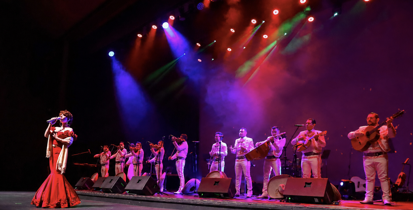 Full mariachi band in formal white attire with female vocalist performing live in New Jersey